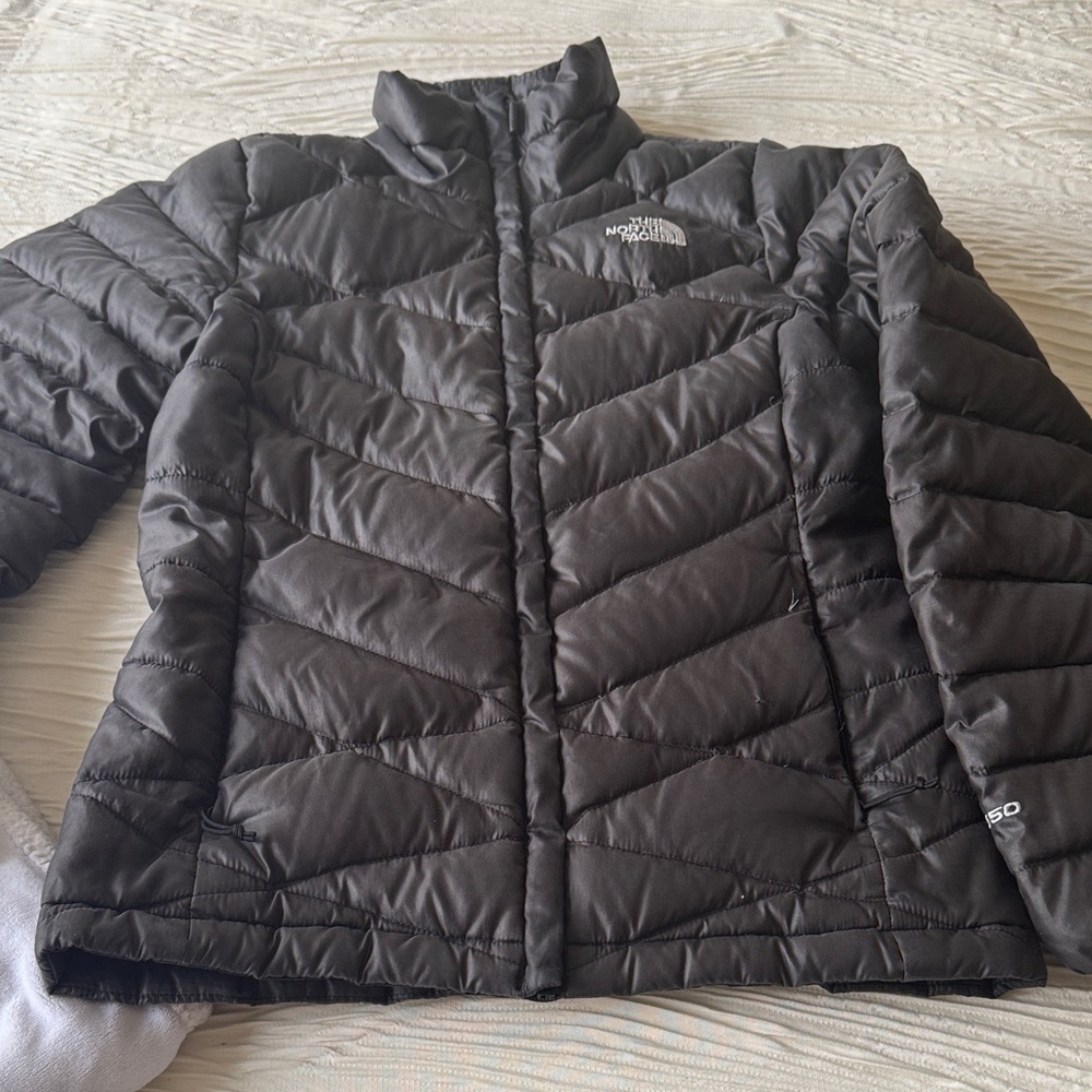 The North Face Women's Dark Gray Puffer Jacket has small rip near end of sleeve